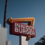 a red and white sign that says in - n - out burger