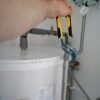 person holding yellow and gray hand tool