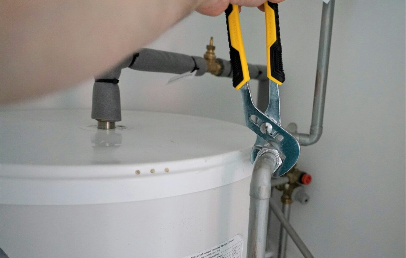 person holding yellow and gray hand tool