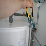 person holding yellow and gray hand tool